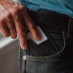 Slim Leather Card Holder wallet in black by Solid Leather in a front pocket of jeans.