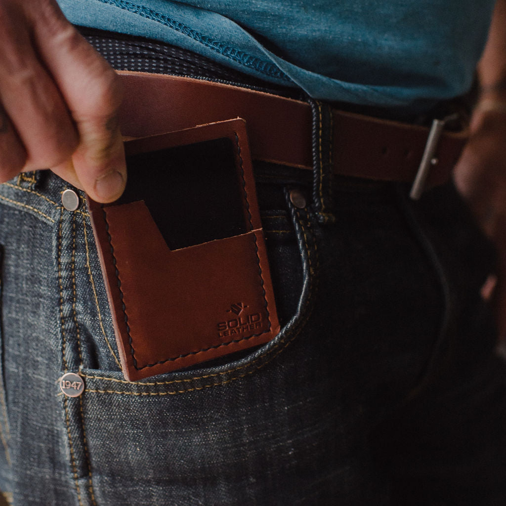 a slim Solid Leather cardholder wallet into front pocket of jeans